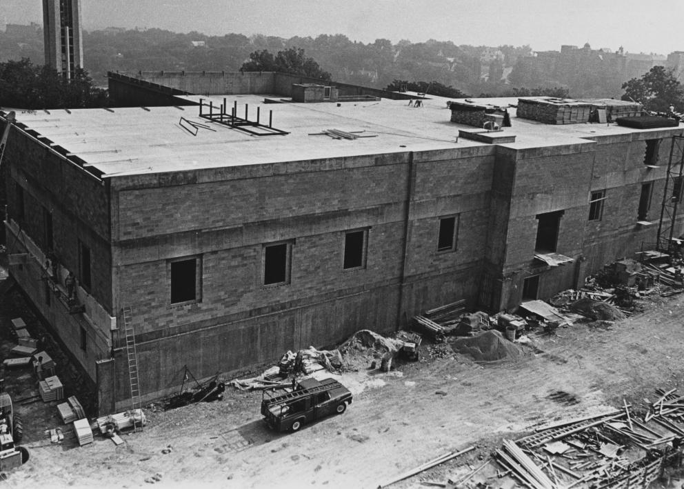 Black-and-white photograph of exterior work nearing completion. The library structure is largely built, but the terrace has not been started.