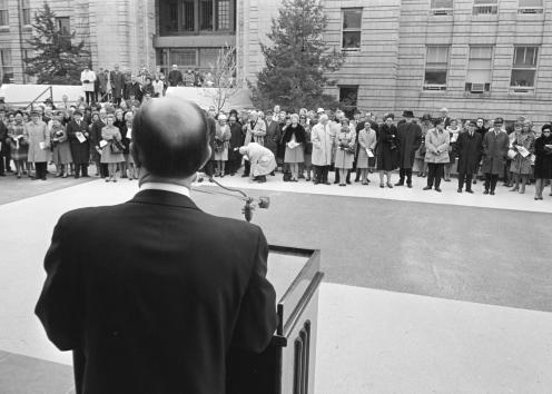 Black-and-white photograph of the crowd at the dedication, taken from behind the speaker at the podium and facing the terrace and Strong Hall.
