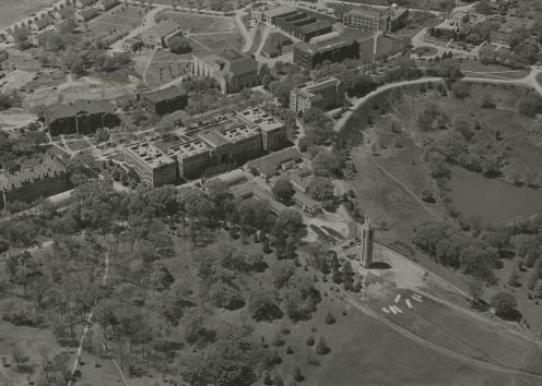 Black-and-white photograph of the KU campus, specifically the area between Strong Hall and the Campanile.